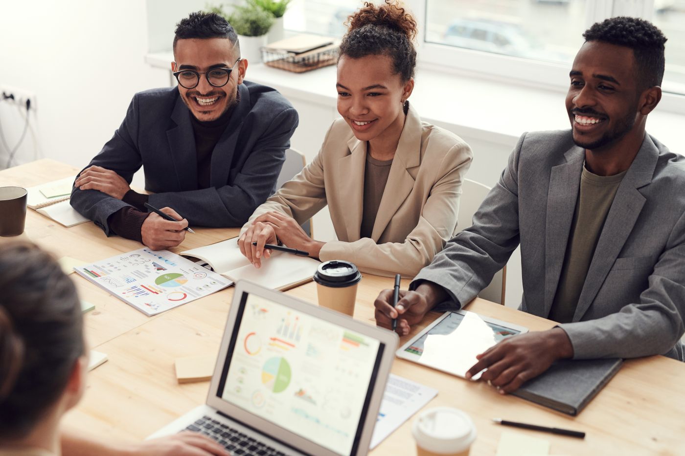 Professionals in a bright workspace discussing a marketing plan